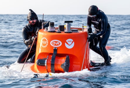 Swimmers prepare the human-occupied submersible for recovery.