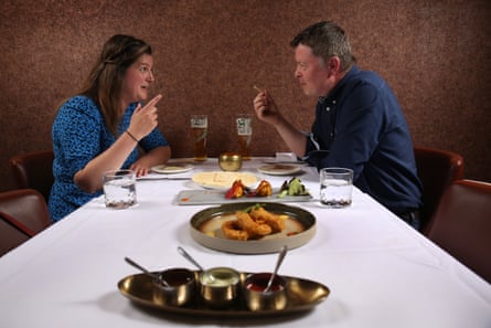 Nyree and Karl eating and chatting across a restaurant table