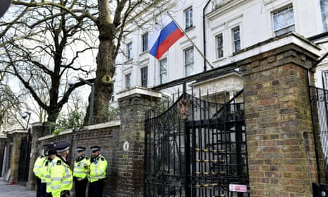Police officers stand on duty outside the Russian Embassy in London.