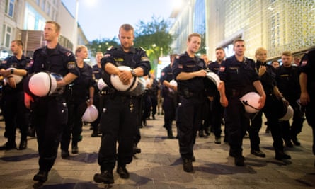 Police remove their helmets as the march made its way through Vienna.
