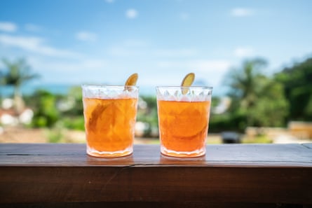 two cocktails on a ledge with a blue sky in the background