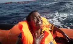 LAMPEDUSA, ITALY - MAY 24: A woman cries after losing her baby in the water as she sits in a rescue boat from the Migrant Offshore Aid Station (MOAS) 'Phoenix' vessel on May 24, 2017 off Lampedusa, Italy.  (Photo by Chris McGrath/Getty Images)