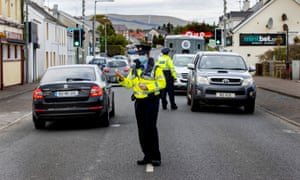 Members of an Garda Siochana while checking a random vehicle in the village of Muff, County Donegal, on the border with Northern Ireland.