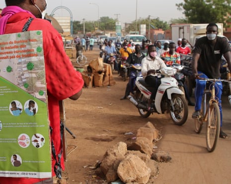 A man uses a microphone to deliver a public service announcement about the coronavirus outbreak in Ouagadougou, Burkina Faso