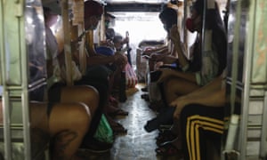 Passengers of a jeepney bus are separated by plastic sheets to help curb the spread of Covid-19 in Quezon city, Philippines, as drivers were recently allowed back on the road after months of not being able to work