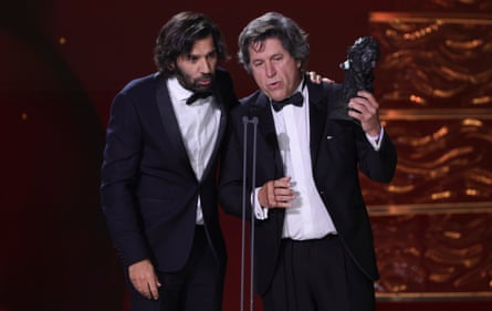 Enrique Costa, left, and Miguel Morales accept on behalf of writer director Jacques Audiard the best European film award for Emilia Pérez during the 39th Goya Awards ceremony in Granada, Spain.