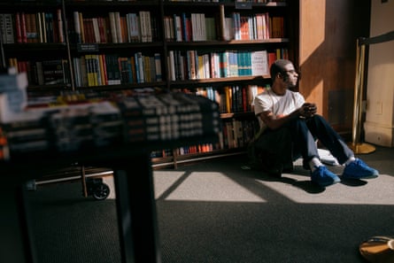 As shoppers explore the book aisles, Jalein James, 21, enjoys the comforts of a quiet corner on the fourth floor of Barnes and Noble at Union Square.