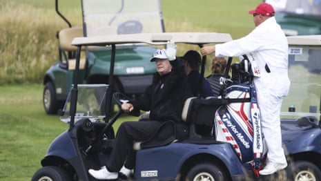 President Trump waves to protesters as he plays golf in Scotland – video
