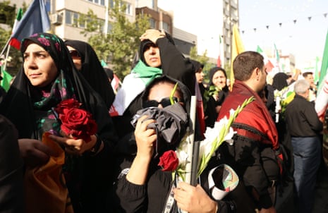 Iranian people mourn during a funeral ceremony for Iranian military and scientists who were killed in recent Israeli airstrikes.