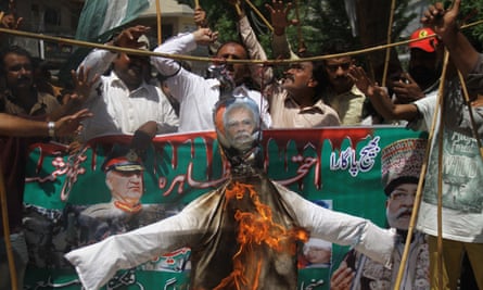 People burn an effigy of the Indian prime minister, Narendra Modi, in Hyderabad, Pakistan