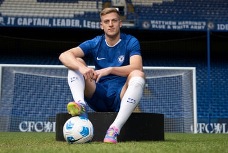 Liam Delap poses for a photo at Stamford Bridge in his new Chelsea kit.