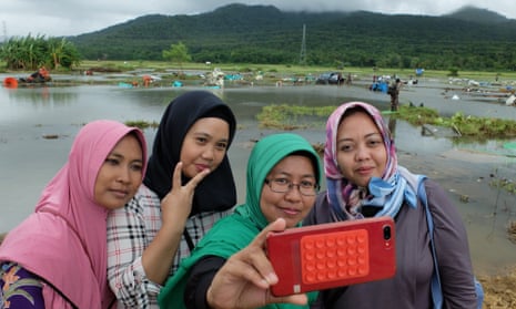 Solihat and her friends pose for a photo in front of the devastated field in Banten province.