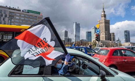 Drivers with flags take part in a protest of Polish women’s rights activists using cars and bicycles to block central Warsaw.