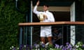 Carlos Alcaraz poses with the trophy and waves to the crowd on the balcony after winning the Wimbledon 2024 men's singles final against Novak Djokovic.