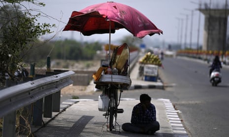 Bicycle vendor sits in shade of parasol