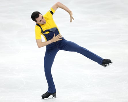 Tomàs-Llorenç Guarino Sabaté competes wearing blue overalls and a yellow T-shirt in the men’s short program of the European Figure Skating Championships in Sheffield