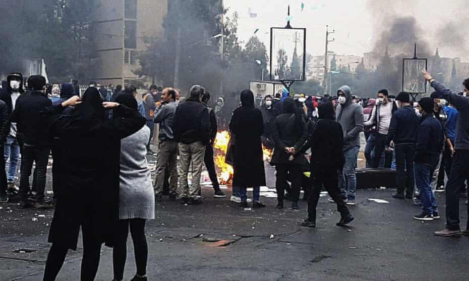 Protesters block a road in Tehran during demonstrations against fuel price rises in Iran