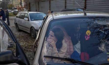 A Ukrainian woman and her family in their car, yesterday, after they managed to flee from Russian-occupied Kherson.