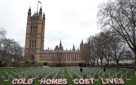A mock cemetery outside Houses of Parliament with letters spelling out 'cold homes cost lives'