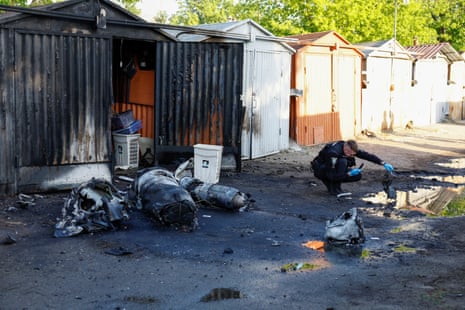 A police officer inspects debris in Kyiv.