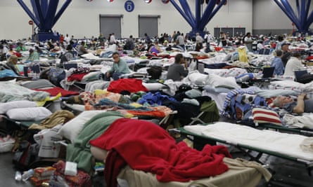 People rest at the George Brown Convention Centre which has been opened as a shelter in Houston, Texas, after Hurricane Harvey.