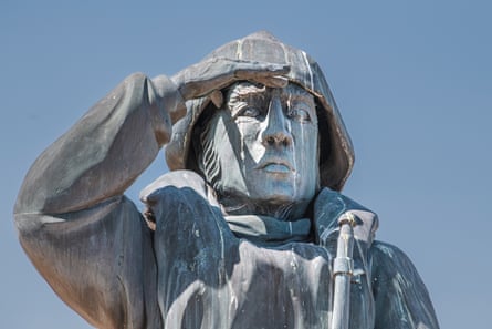 A close-up of Lowestoft’s lifeboatman statue, hand raised to shield his eyes and covered in gull guano