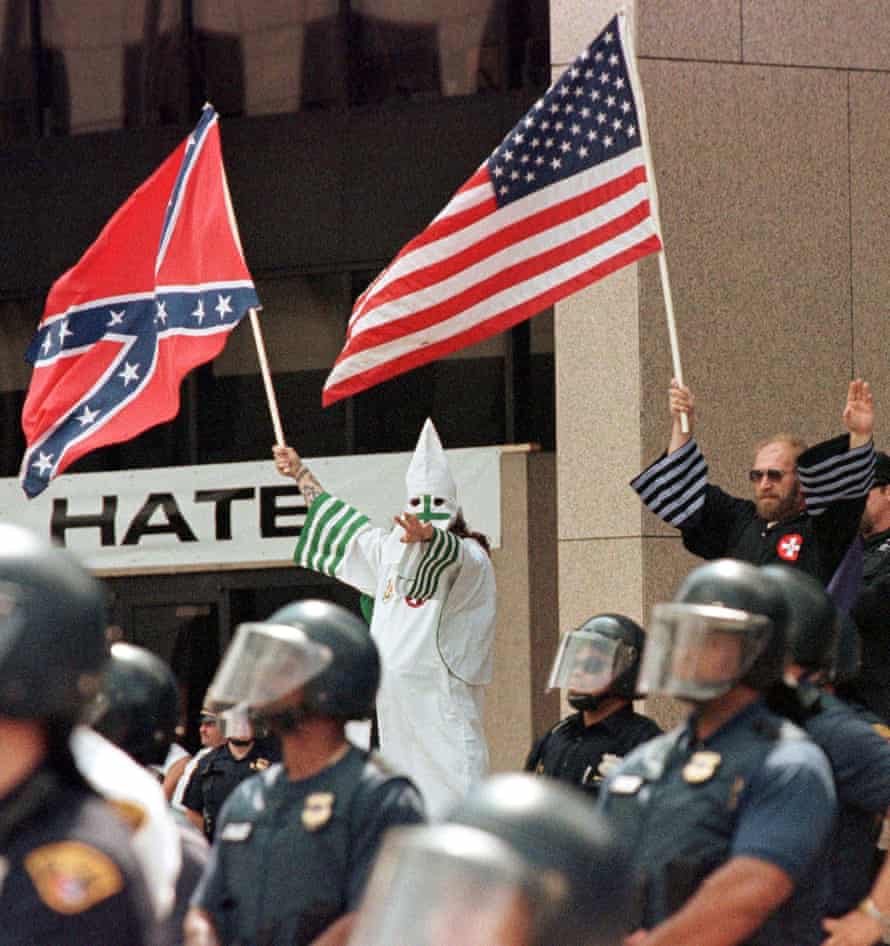 Darker uses … Ku Klux Klan leaders wave flags at a rally in Cleveland, Ohio.