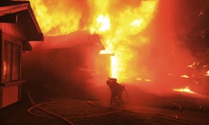 A firefighter struggles to protect a home from catching fire in Coffey Park, 9 October 2017 in Santa Rosa, California.