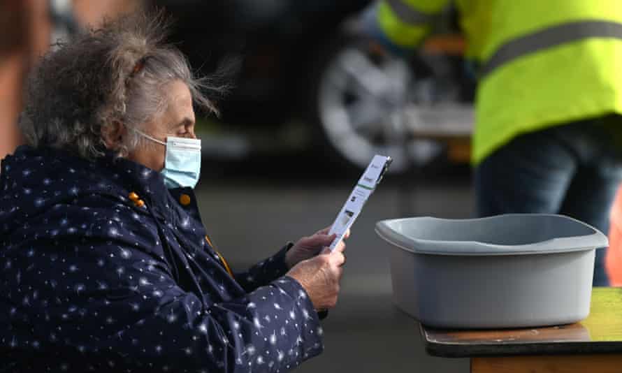 A member of the public reading an instruction sheet before taking a coronavirus test today at a temporary Covid testing facility in Manchester.
