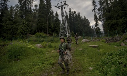 Indian army soldiers walk back after a rescue mission in Gulmarg.