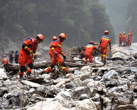 Firefighters conduct search and rescue operations along a river in Tibet
