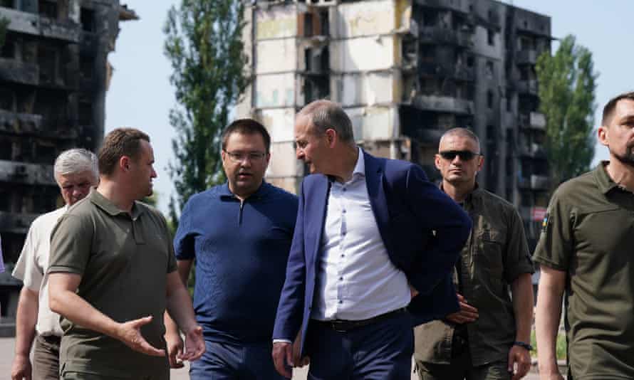 Taoiseach Michael Martin with local officials viewing the damage to the Borodianka area of Kyiv.