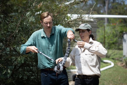 Joe and Christina handling a tiger snake