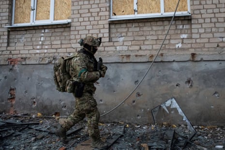 A Ukrainian serviceman walks along a building in the frontline town of Bakhmut, in Ukraine’s Donetsk region.