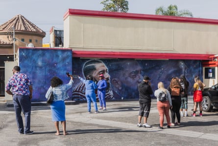 Fans come to take pictures and pay their respects to in front of the Nipsey Hussle murals on Wednesday.