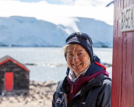 Amanda Barry next to a hut in front of a lake and mountains