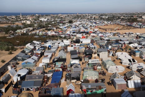 Displaced Palestinians, who fled their houses due to Israeli strikes, shelter at a makeshift tent camp in Rafah in the southern Gaza Strip.