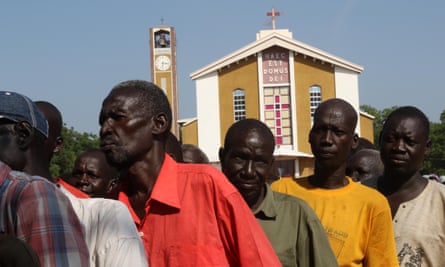 Displaced people line up to receive aid at St Theresa cathedral in Juba, where more than 2,000 people are seeking shelter.