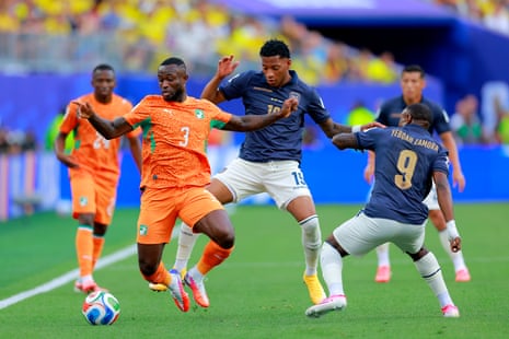 Ghislain Konan (L) of Cote D'Ivoire and Gonzalo Plata (R) of Ecuador fight for the ball