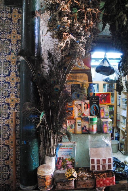 Goods including peacock feathers and an empty tortoise shell outside a herbal practitioner’s shop in the Souq El Blat