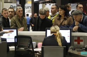 People gather at the airline information desk at of Russian airline Kogalymavia’s desk at Pulkovo airport in St Petersburg