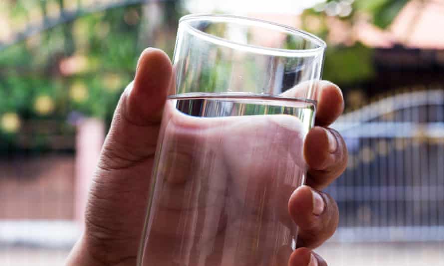 hand with glass of water