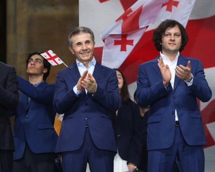 Two men in suits applauding