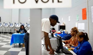 Charles Poole, 70, checks in to his polling site in Georgia, where an elections board is voting on a plan to close polling places in Randolph county.