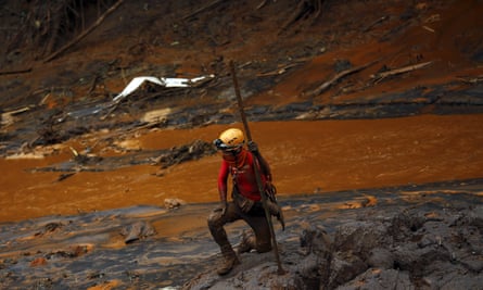 A rescue worker at Bento Rodrigues district after a dam owned by Vale SA and BHP Billiton Ltd burst in Mariana, Brazil, in November 2015