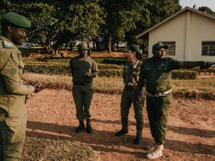 Christine Lain smiles as she listens to a ranger as two others stand nearby
