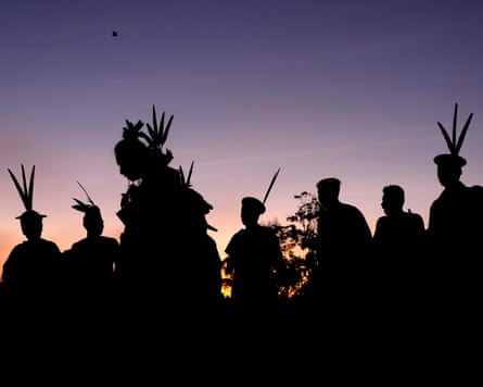 Asháninka Indigenous people in silhouette against the dawn sky