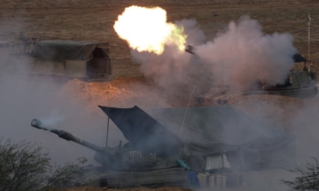 An Israeli artillery unit fires from a position near the Israeli-Gaza border in southern Israel