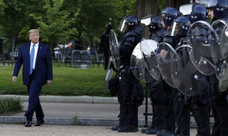 President Donald Trump walks past police in Lafayette Park after posing with a Bible outside St John’s Church across from the White House on 1 June 2020.