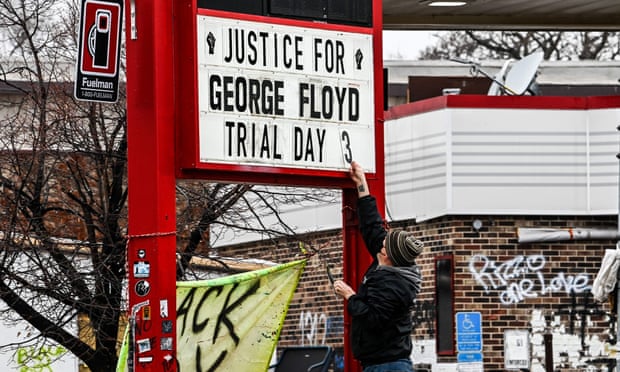 A man changes the number of a sign board at a makeshift memorial of George Floyd before the third day of jury selection begins in the trial of former Minneapolis police officer Derek Chauvin who is accused of killing Floyd, in Minneapolis, Minnesota on Wednesday.